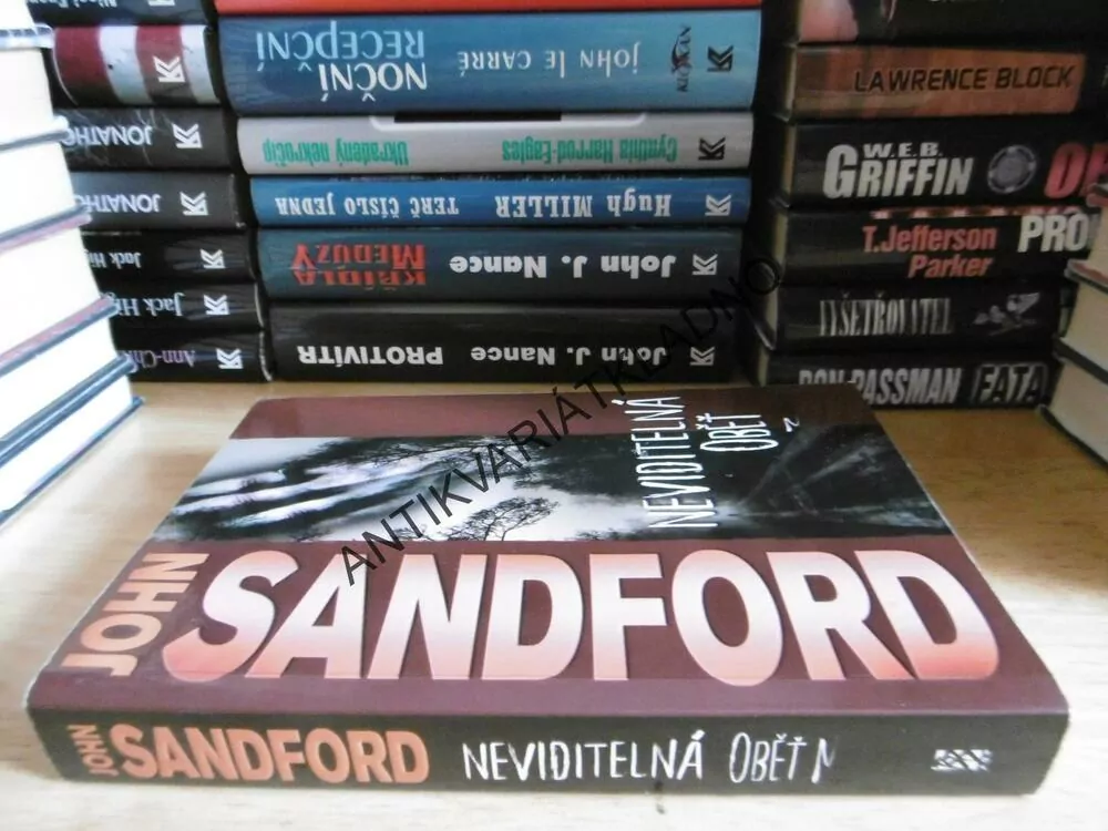 NEVIDITELNÁ OBĚŤ, JOHN SANDFORD, **an