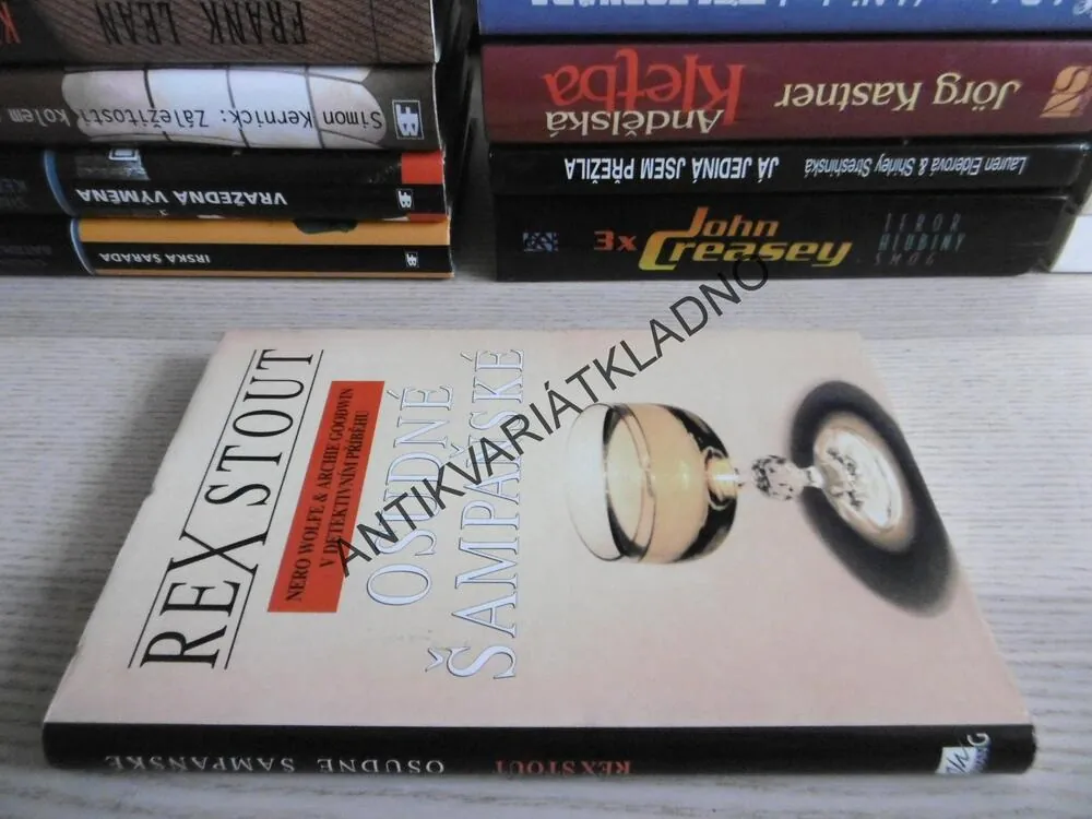 OSUDNÉ ŠAMPAŇSKÉ, REX STOUT, **an