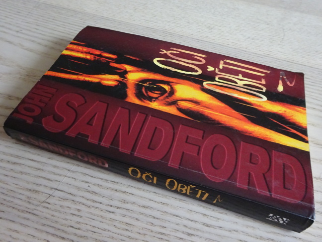 OČI OBĚTI, JOHN SANDFORD, **an