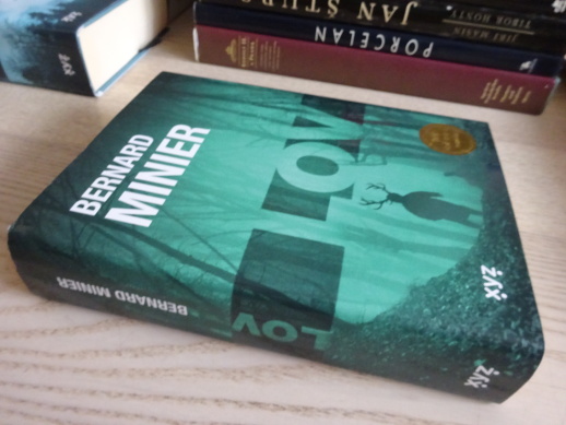 LOV, BERNARD MINIER, **an