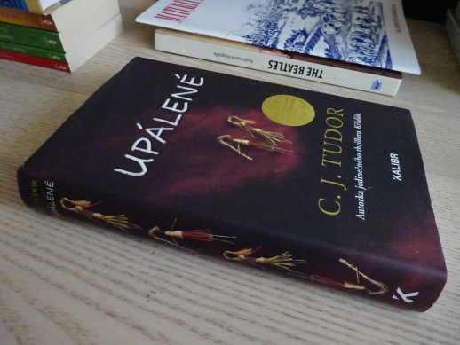 UPÁLENÉ, C. J. TUDOR, **an