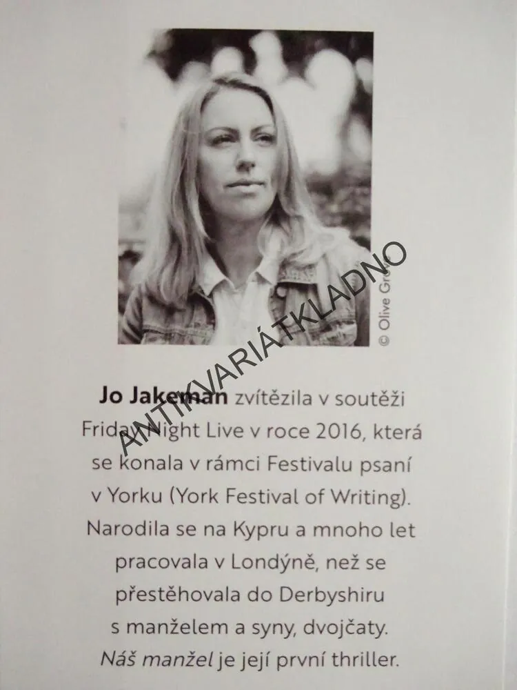 NÁŠ MANŽEL, JO JAKEMAN, **an